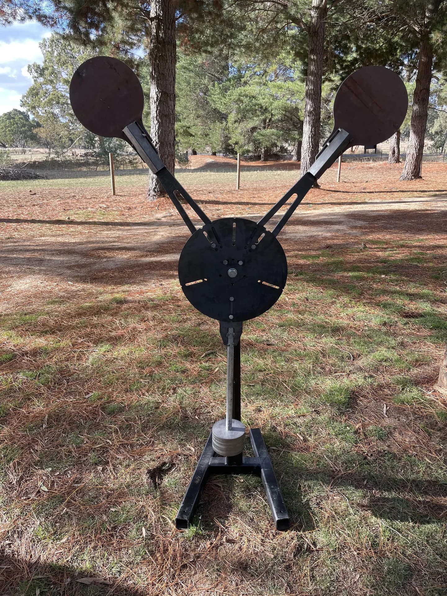 A Lorco reactive target with two circular steel plates, photographed outdoors.
