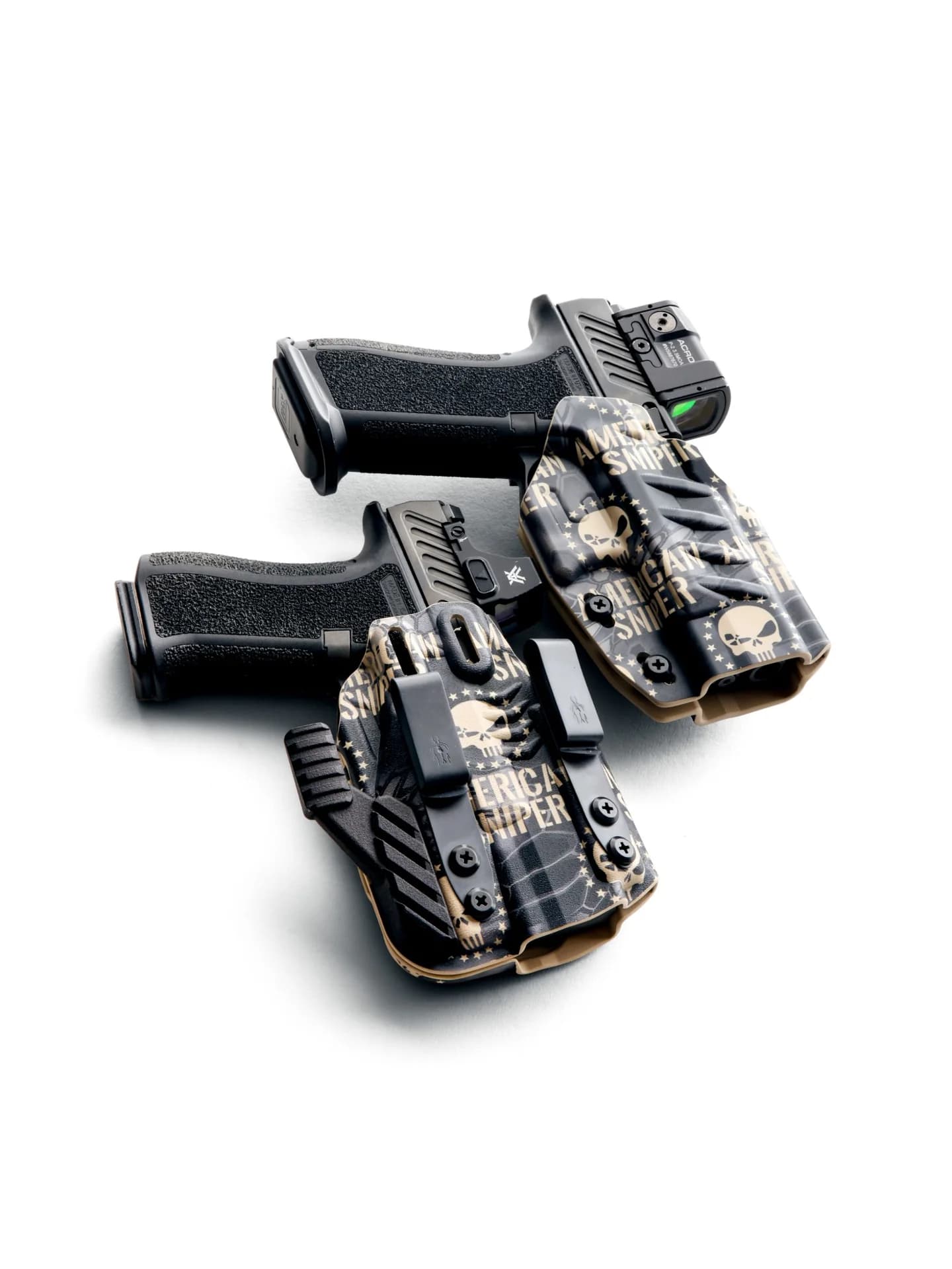 Two American Sniper holsters and SIG Sauer pistols laid out on a white surface.