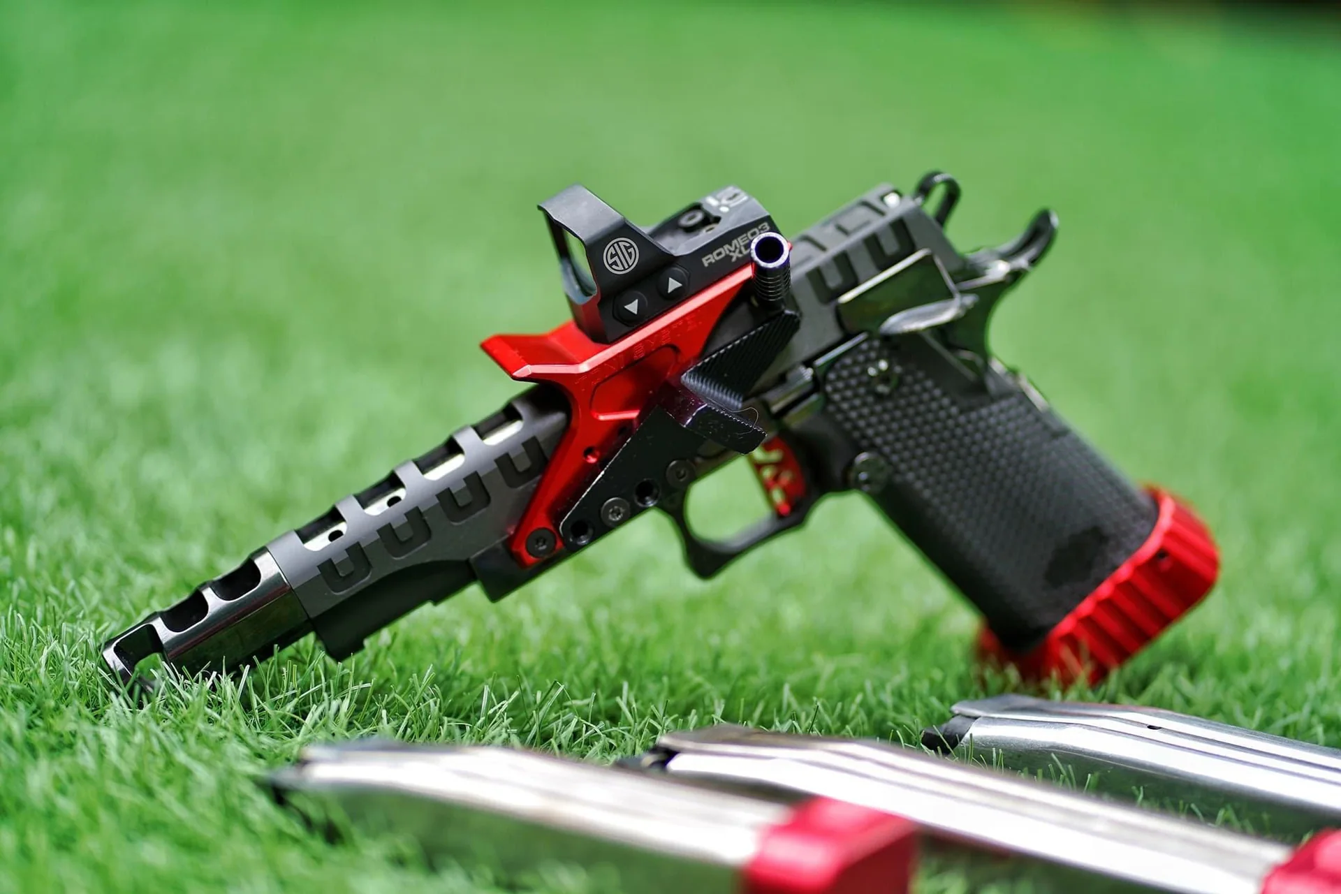 A red and black 2011 Open Pistol finished in Cerakote.