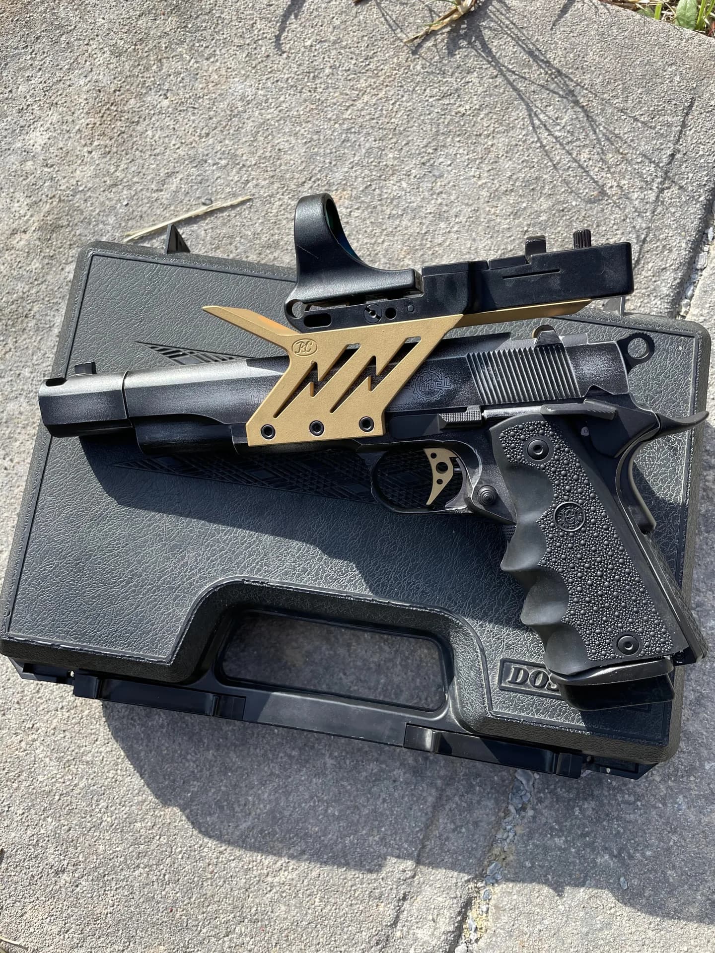 A custom Colt 1911 with gold-accented Cerakote detailing from the Lorco project archive.