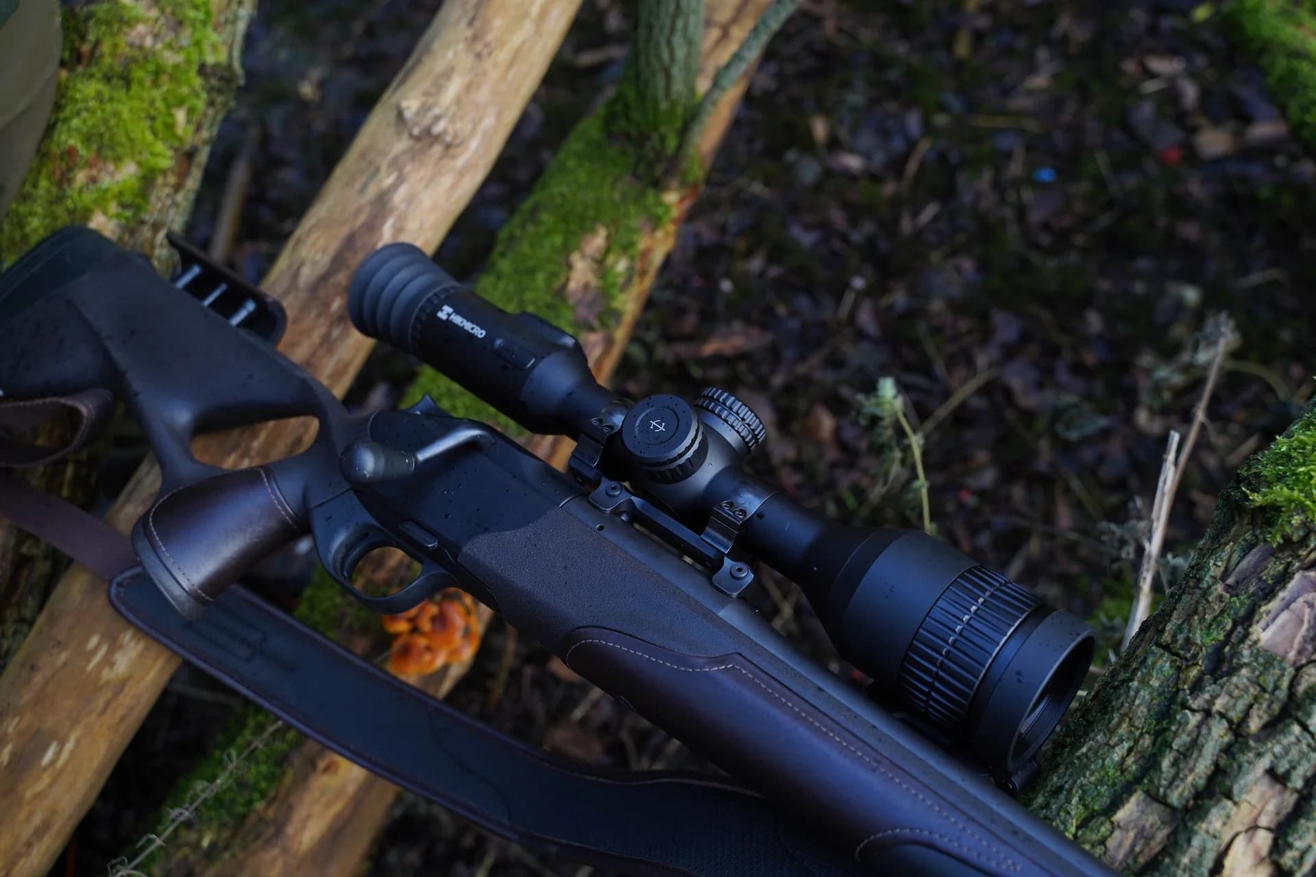 A rifle fitted with a thermal optic, photographed outdoors.